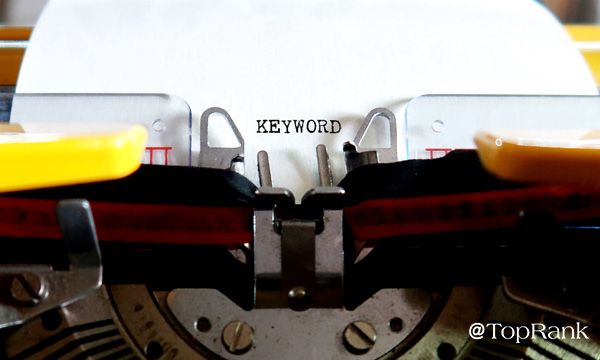 Typewriter with keyword on sheet of paper image.
