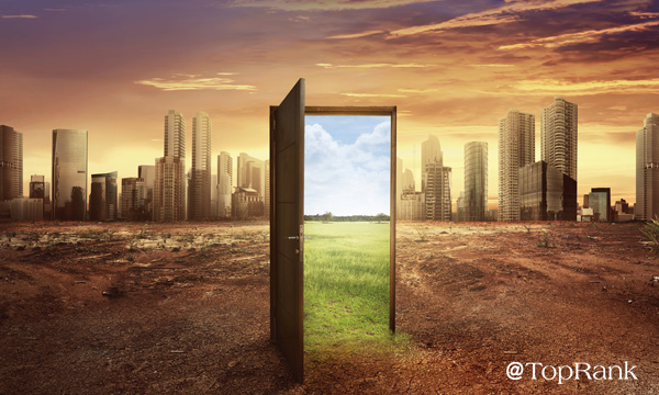 Doorway open to green pastures in an urban cityscape image.