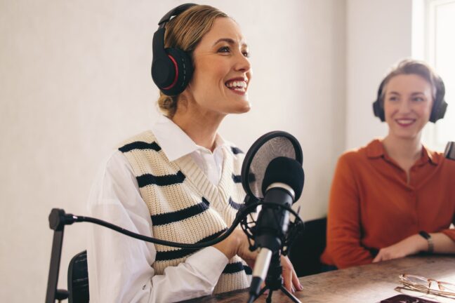 Happy,Female,Podcast,Host,Smiling,While,Presenting,A,Guest,On